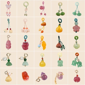 Selection of diverse colorful charms featuring flowers, butterflies and gourds for DIY jewelry