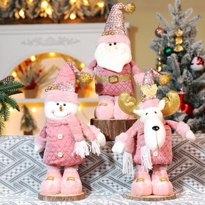 Pink Christmas plush figurines with golden sequins and telescoping legs on wooden base