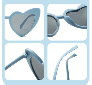 Detail view of heart-shaped sunglasses featuring blue frames and metal hinge construction