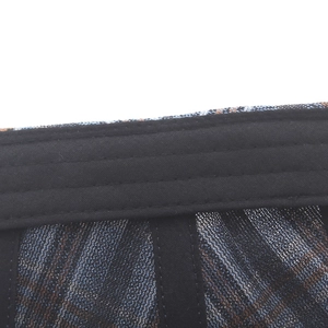 Close-up of checkered beret interior showing black sweatband and breathable mesh lining
