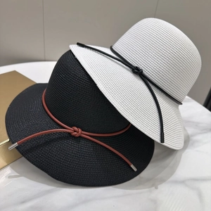 Détail de chapeaux en paille tressée avec cordons en cuir et nœuds aux embouts métalliques