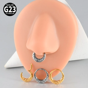 Detail of G23 titanium hinged rings with hammered texture shown on a silicone nose model
