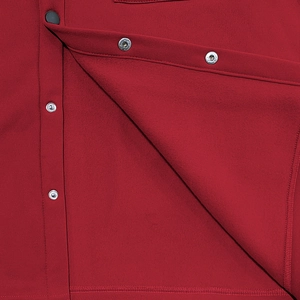 Close-up of deep red workwear jacket showing metallic snap buttons and fabric texture