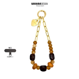 Phone charm with amber resin beads, gold metal chain, and heart pendant on white background