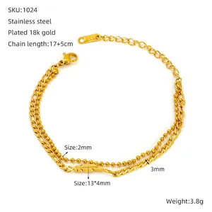 Detailed view of dual-layer stainless steel gold chain bracelet with feather pendant