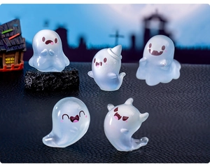 Detail showing five mini luminous Halloween ghost figurines in various cute expressions