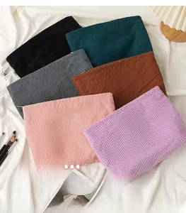 Macro detail of various corduroy cosmetic bags with vertical ribbed texture in six colors