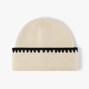 Chique crème en zwarte gebreide muts met contrasterende zigzag gehaakte randdetails