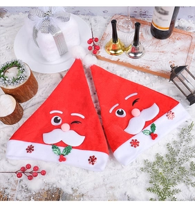 Detailed close-up of plush Santa hats with snowflake sequins and festive decorations
