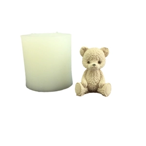 Teddy bear silicone mold and finished beige 3D candle figure on white background