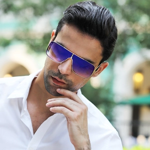 Detail of gradient purple lenses and gold metal frames on oversized square sunglasses
