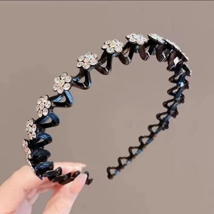 Detail of black wavy non-slip headband featuring elegant floral rhinestones for women