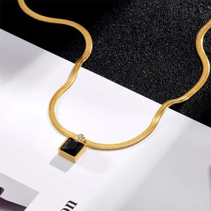 Gold snake chain necklace featuring a black square pendant and clear zircon accent