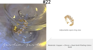 Detail of adjustable gold ring with leaf design featuring zircon stones and real gold plating