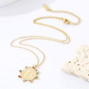 Golden stainless steel necklace with multi-color gemstone religious pendant on white stone