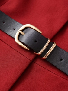 Detailed view of red twill knit fabric with a black leather belt and gold buckle