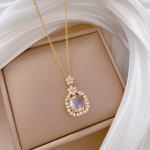 Titanium steel gold necklace featuring a floral pendant with oval green gemstone and crystals