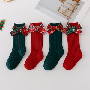 Christmas children socks with festive bows in red and green ribbed cotton knit fabric