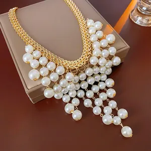 Luxurious French gold woven necklace with multi-layer pearl tassels on a jewelry box