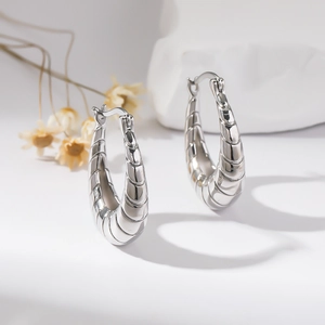 Polished silver-plated copper croissant hoop earrings with a sleek minimalist design