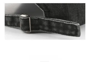Detail shot of vintage washed grey baseball cap featuring adjustable metal strap buckle