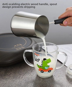 Close-up of stainless steel milk pot with eagle spout pouring milk into a glass cup