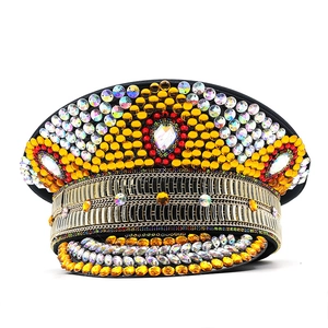 Detailed view of golden party hat with sparkling rhinestones and colorful gemstones