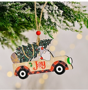 Close-up of wooden Christmas truck ornament with JOY print and red bead on hemp rope