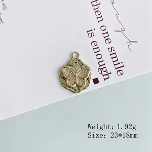Macro detail of a gold butterfly pendant with rhinestones on a hammered metal disc