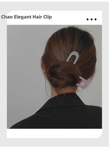 Detail of matte lavender U-shaped hair pin holding a bun hairstyle on model's head