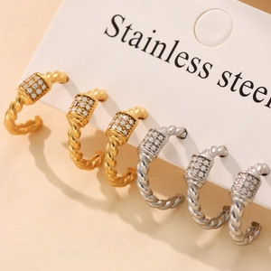 Twisted hoop earrings in 18k gold and silver stainless steel with sparkling 5A zircon stones