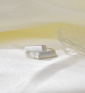 Close-up of minimalist S925 sterling silver crossover open ring with geometric design