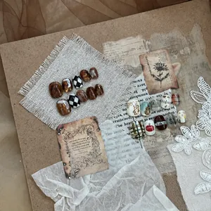 Artistic layout of amber marble and hand-drawn bear nail art sets on vintage paper and lace