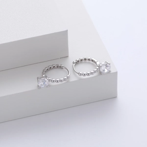 Detail shot of S925 sterling silver hoop earrings with round-cut zircon and bead edge