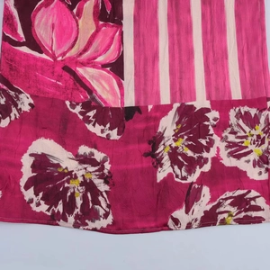 Floral print silk midi dress featuring vibrant rose patterns and vertical stripes