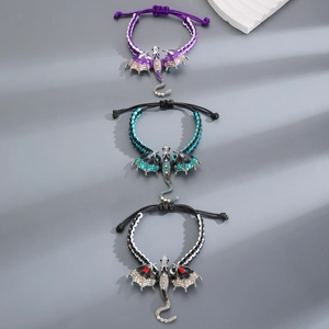 Detailed macro view of woven dragon bracelets with colorful enamel wings and crystal inlay