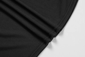 Detailed macro shot of high-quality black ribbed knit fabric showing vertical texture
