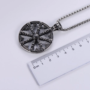 Close-up of vintage silver viking compass pendant showing 4cm diameter on a ruler