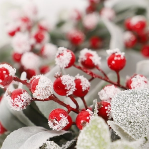 Christmas wreath with red berries and frosted eucalyptus leaves on wire frame