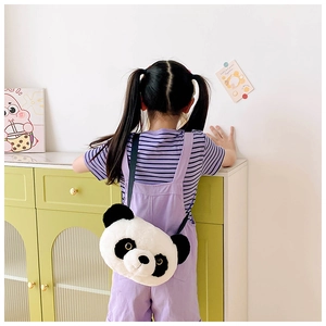 Detail showing a girl wearing a large plush panda shoulder bag with soft furry texture