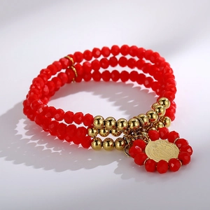 Detailed macro view of triple-layer red glass beads with a gold coin religious pendant