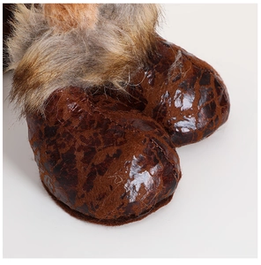 Detailed view of plush reindeer fabric stitching and faux leather texture details