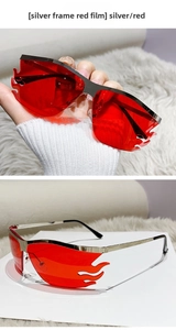 Detail of flame-shaped rimless sunglasses with silver metal frame and red lenses