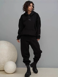 Women's black loungewear set featuring a hooded sweatshirt and high-waisted joggers