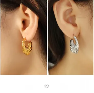 Detailed comparison of gold and silver chunky C-shaped hoop earrings with pleated texture