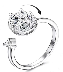Detail view of a silver spinning ring featuring a sparkling zircon stone for stress relief