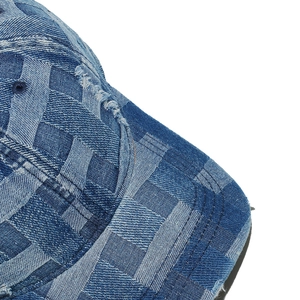 Macro shot of blue denim checkerboard baseball cap with distressed fringe details