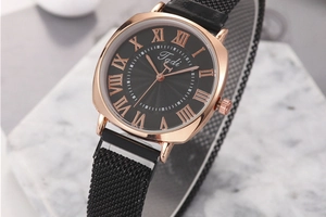 Macro shot of rose gold square watch case with sunray dial and Roman numerals