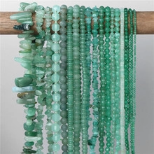 Detailed view of various natural green stone beads including faceted and smooth styles