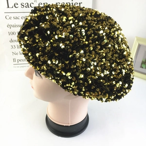 Fashionable black velvet beret with shiny gold sequins for women in a side view